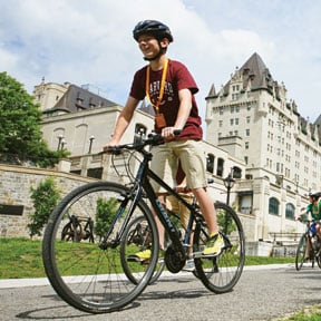 Student riding bike on tour