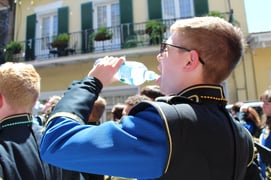 Boy drinking water during parade