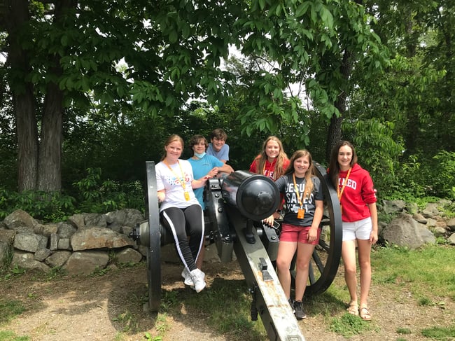 Students posing with cannon 